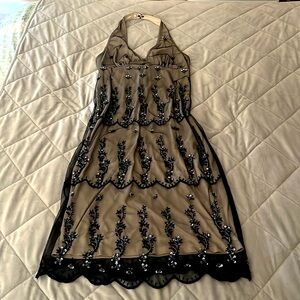 Classy black beaded halter dress (sheer) over a cream layer.